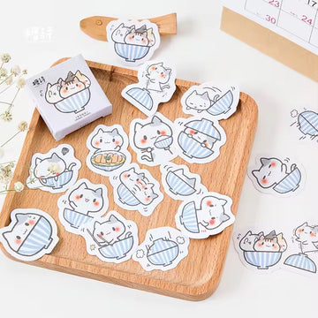 A bowl of cat themed notebook sticker box